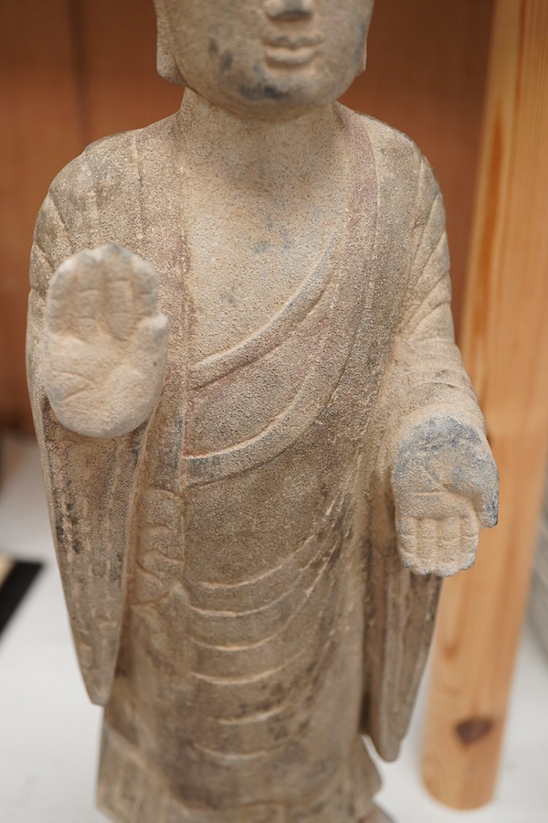 A Chinese composition stone standing figure of Buddha, 48cm high